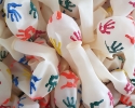 many uniflated balloons with print hand